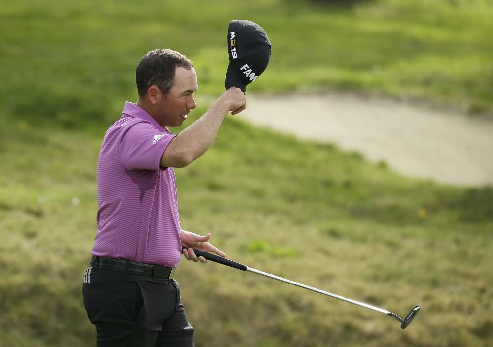 Chez Reavie tips his cap after finishing play at Monterey Peninsula in the Pebble Beach Pro-Am on Thursday. Reavie’s 8-under 63 gave him a one-stroke lead in the tournament played at three courses.