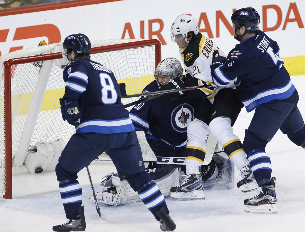 The Bruins’ Loui Eriksson scores on Winnipeg goaltender Connor Hellebuyck in the first period.
