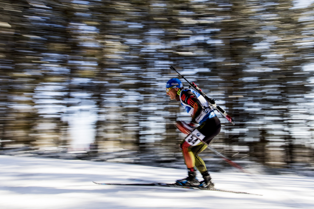 Erik Lesser of Germany pushes his way up a hill Thursday at Presque Isle as he competes in the 10-kilometer sprint at the BMW IBU World Cup Biathlon, in which competitors ski with .22-caliber rifles strapped to their backs.