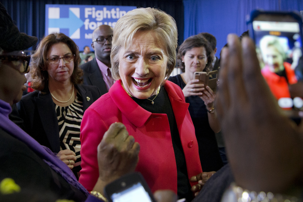 Democratic presidential candidate Hillary Clinton reacts to a greeting from a child after speaking during a town hall meeting in Denmark, S.C., Friday.