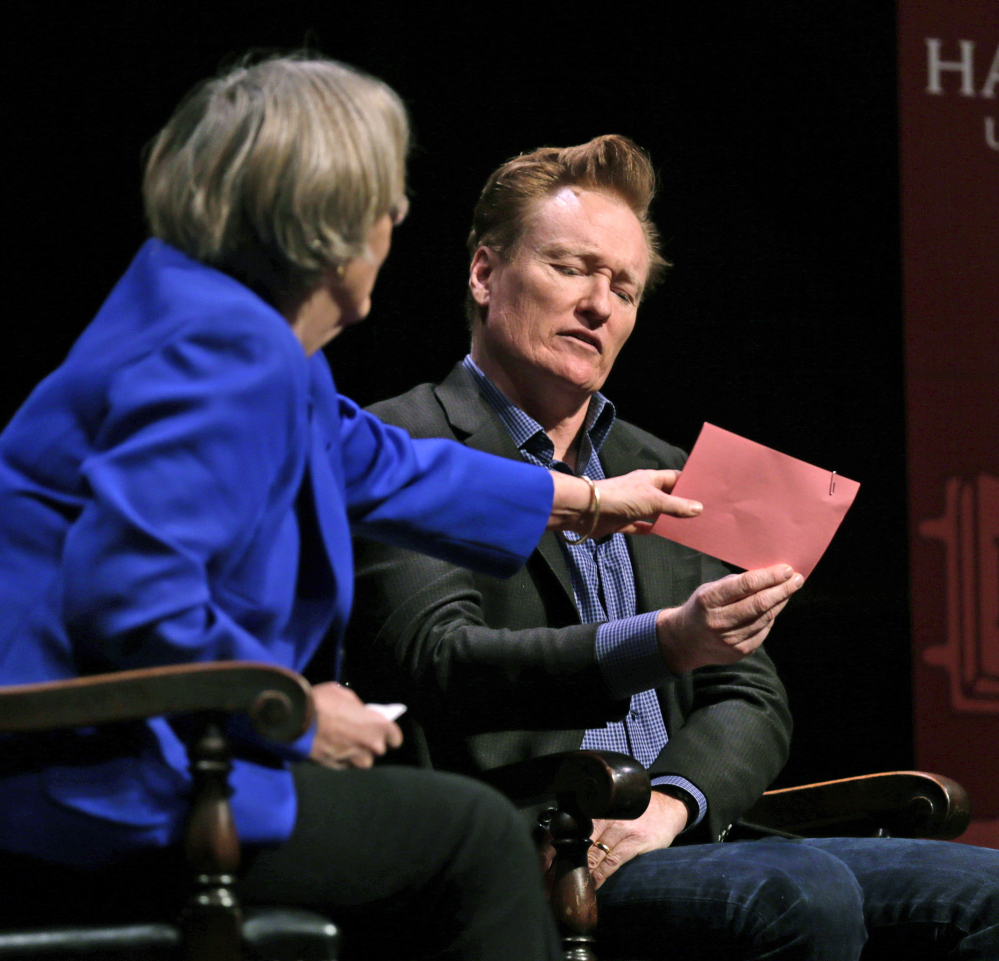 Television host Conan O’Brien sneaks a peek at prepared questions as Harvard President Drew Faust grabs them out of his hand at Harvard University on Friday.
