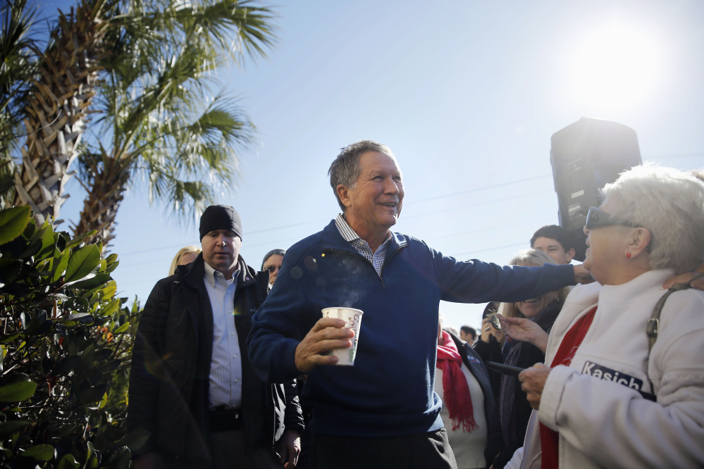 Republican presidential candidate John Kasich meets with people at a campaign stop Thursday in Pawleys Island, S.C.