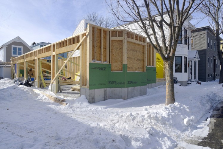 An addition is under construction on a home on Munjoy Street in Portland. Increasing gentrification in Portland neighborhoods has raised the issue of rent control.
John Ewing/Staff Photographer