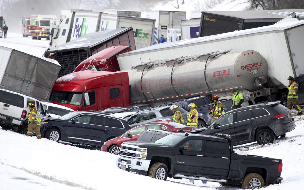 Emergency personnel work at the scene of a crash near Fredericksburg, Pa., on Saturday. State police say a pileup has closed Interstate 78 in central Pennsylvania. 