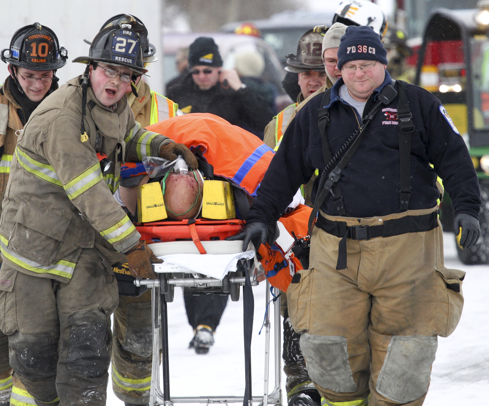 Emergency personnel carry an injured person away from the I-78 crash scene Saturday.
