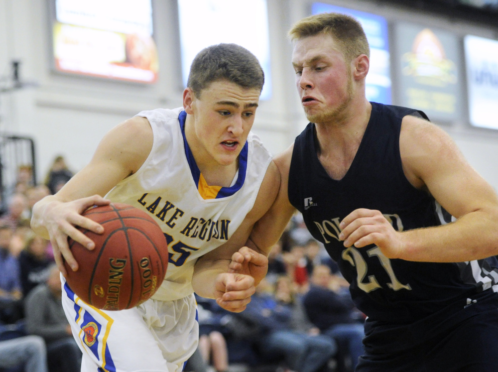 John Fossett of Poland High tries to cut off Jackson Lesure of Lake Region as he drives to the basket during a Class B South quarterfinal Saturday at the Portland Expo. (Photo by Derek Davis/Staff Photographer)