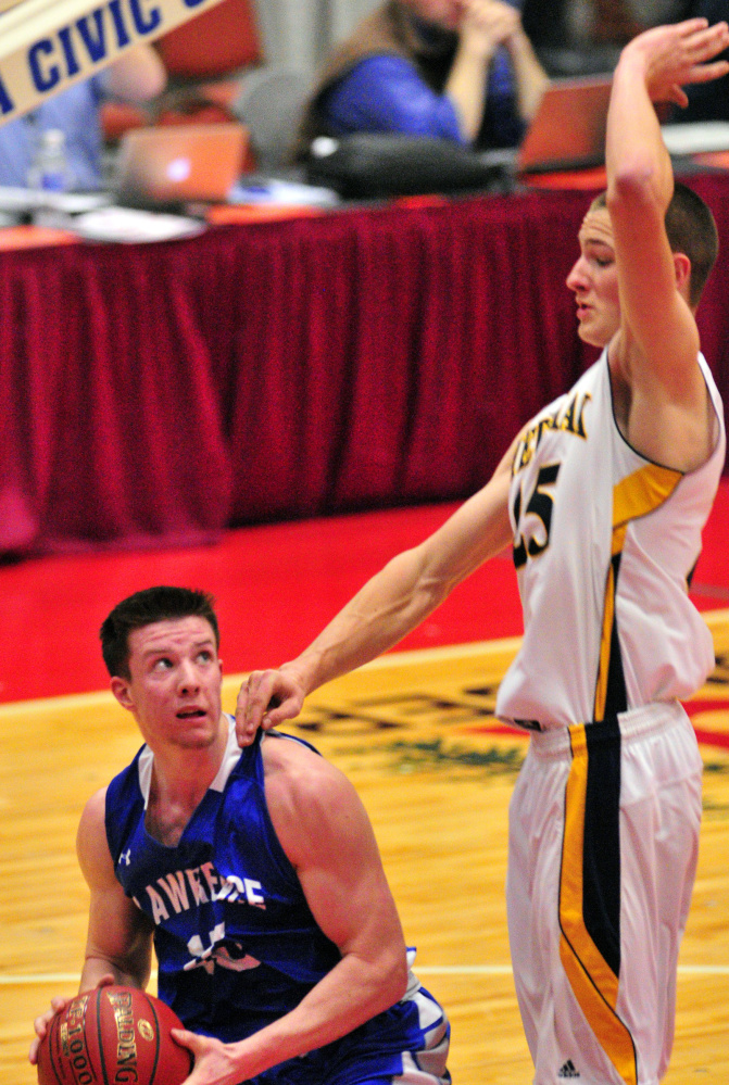 Seth Powers of Lawrence looks for room to shoot Saturday while being guarded by Cameron Allaire of Medomak Valley during Medomak’s 62-44 victory.