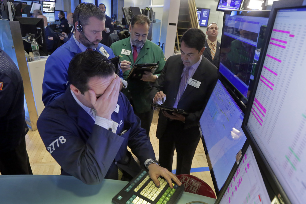 Michael Gagliano, foreground, works with traders at his post on the floor of the New York Stock Exchange on Feb. 1.