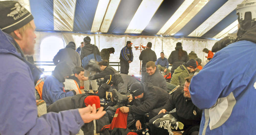 Team members escape the cold in the tournament’s warming tent. Because of the extreme cold, games were shortened to two 15-minute halves Sunday.
