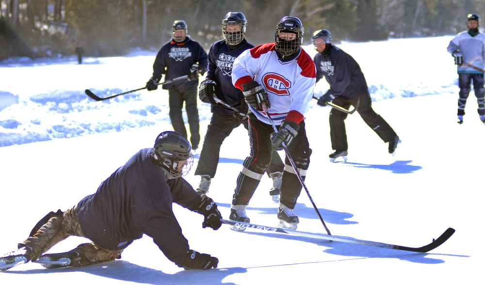 Players face off Sunday in the Maine Pond Hockey Classic at the Snow Pond Center for the Arts in Sidney.
