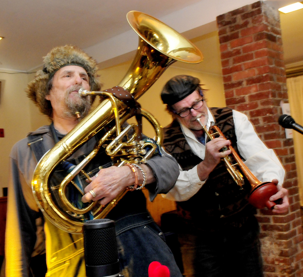 James Fangboner, left, and Wally Warren warm up on their brass instruments Sunday during a fundraiser for nonprofit radio station WXNZ 98.1 at the Somerset Abbey in Madison.