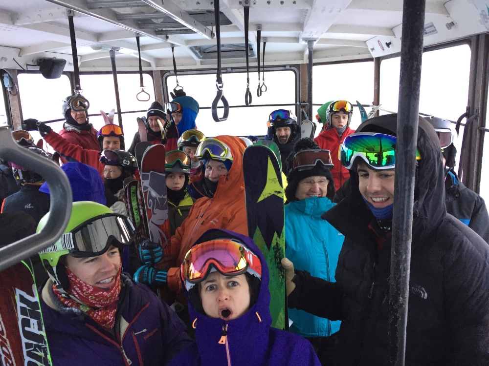People stand in a tram car Sunday, Feb. 14, 2016, after it became stuck 40 feet off the ground in sub-zero temperatures at Cannon Mountain Aerial Tramway in Franconia, N.H. Crews have rescued 48 people from two tram cars at the New Hampshire ski resort after it became stuck. A Cannon Mountain spokesman says officials said there was a service brake issue. Crews do not believe the cold temperature was a factor. No injuries have been reported.
