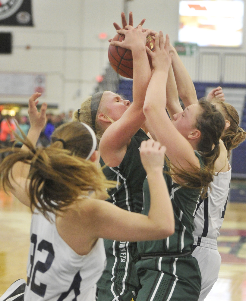 Leavitt’s Chantel Eells pulls down a rebound among a crowd of players. Eells scored 10 of her 12 points in the fourth quarter as the sixth-ranked Hornets advanced to face Greely in the semifinals.