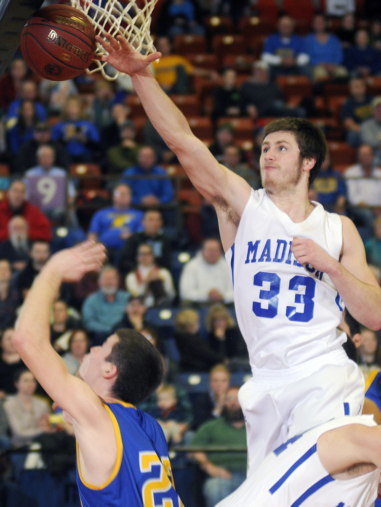 Madison junior center Mitchell Jarvais blocks a shot by Boothbay’s Jacob Leonard during a Class C South quarterfinal Monday afternoon at the Augusta Civic Center.