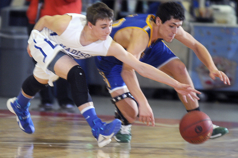 Madison sophomore guard Sean Whalen, left, dives for the ball with Boothbay senior captain Abel Bryer during a Class C South quarterfinal Monday afternoon at the Augusta Civic Center.