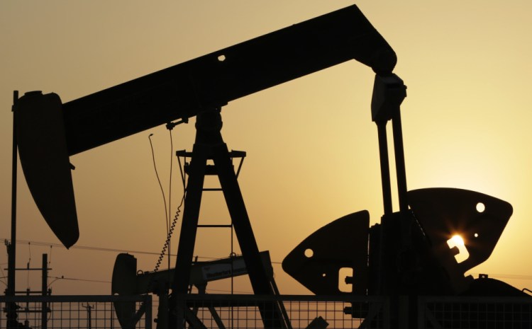 FILE -- In this Sept. 30, 2015, file photo, oil pumps work in the desert oil fields of Sakhir, Bahrain.