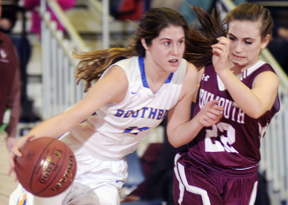 Sidney Wilson, right, of Monmouth Academy, keeps the pressure on Kate Friant of Boothbay during Thursday’s game at the Augusta Civic Center. Boothbay won, 36-34.