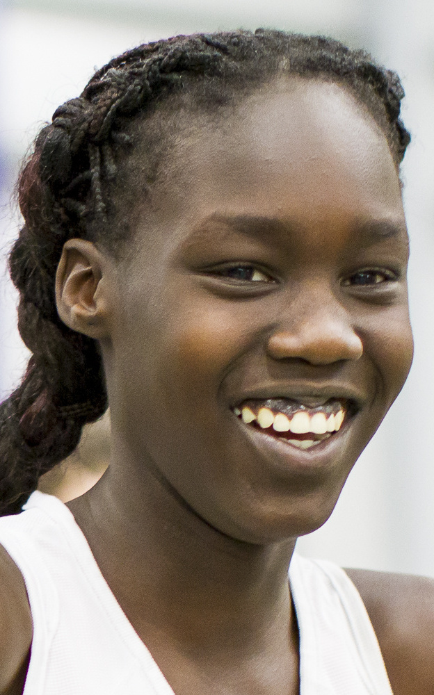 GORHAM, ME - FEBRUARY 7: Nyagoa Bayak,, a freshman from Westbrook, flashes a smile while awaiting her turn for the junior division girls triple jump Saturday at the SMAA indoor track championships at University of Southern Maine's Costello Sports Complex. Bayak placed third in the triple jump (32-0) and first place in the high jump (5-6) and long jump (15-5  ). (Photo by Ben McCanna/Staff Photographer)