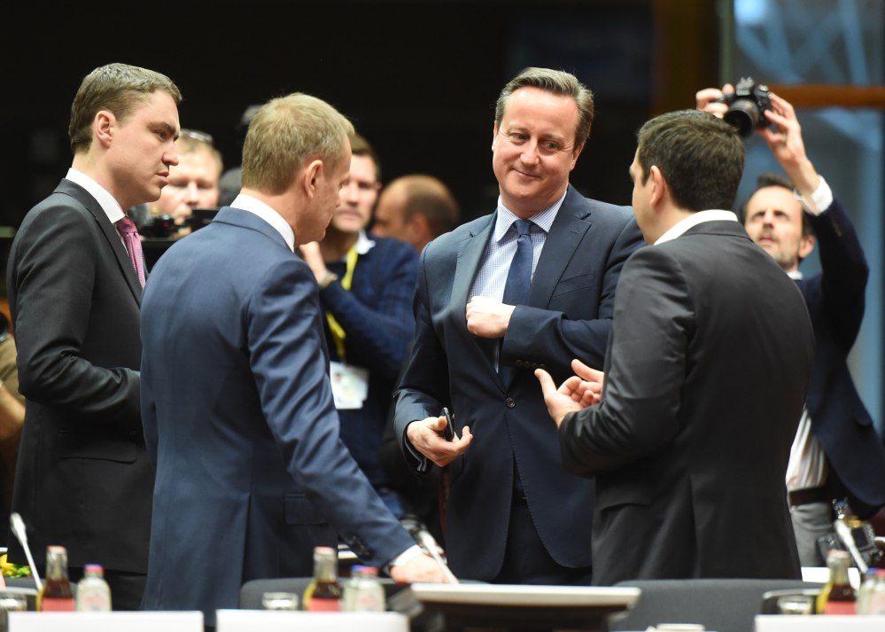 British Prime Minister David Cameron, center, speaks with Greek Prime Minister Alexis Tsipras, right, and European Council President Donald Tusk during an EU meeting Thursday.