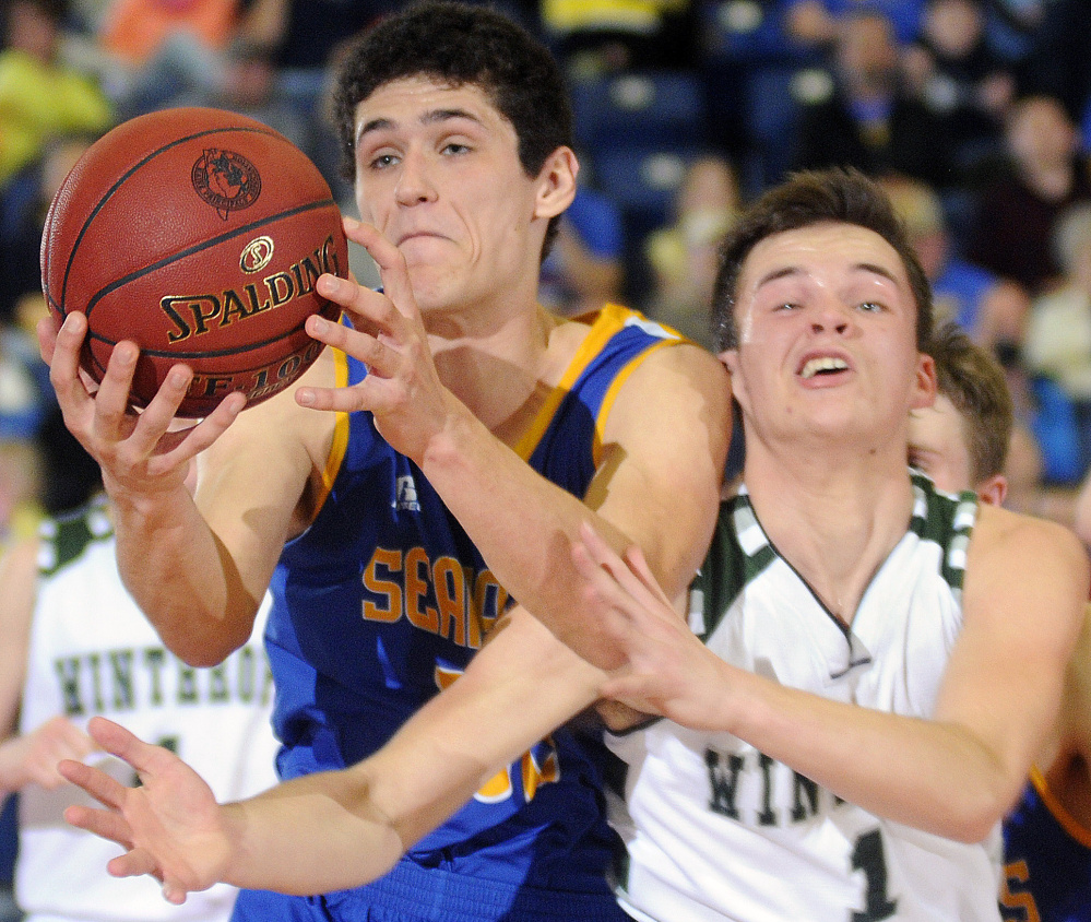 Boothbay’s Abel Bryer, left, collides with Bennett Brooks of Winthrop during a Class C South boys’ basketball semifinal Thursday night in Augusta. Winthrop won, 45-31.