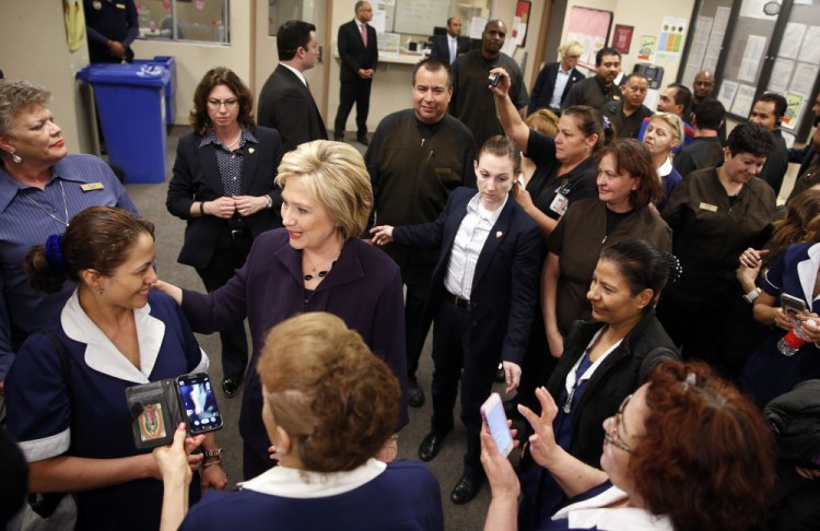 Democratic presidential candidate Hillary Clinton, second from left, meets with employees of Paris Las Vegas during a visit to the hotel and casino Thursday.