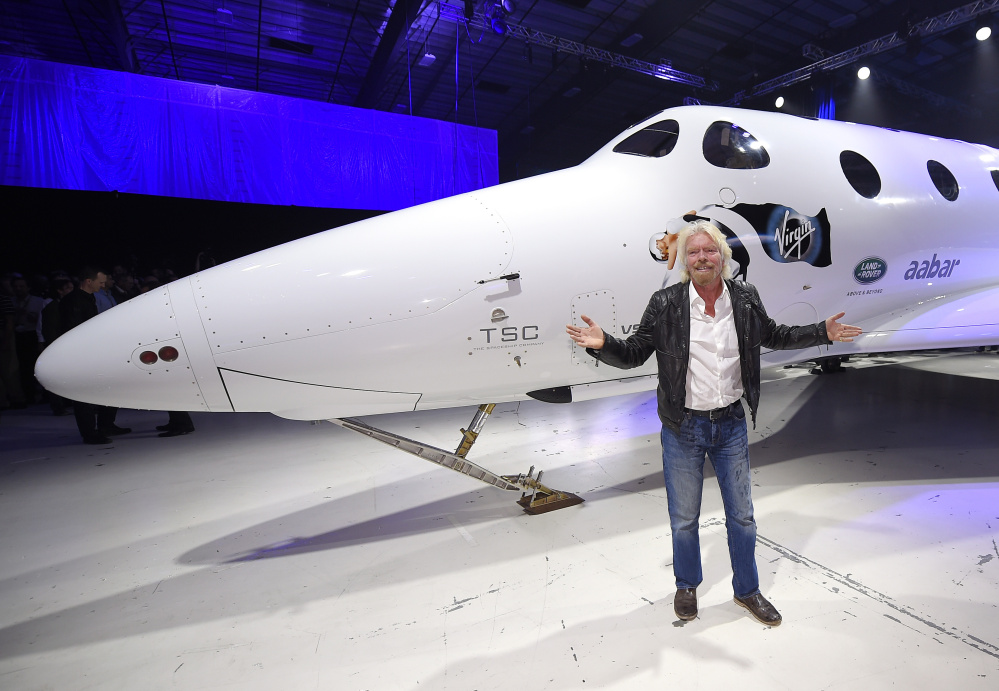 Sir Richard Branson stands in front of Virgin Galactic’s SpaceShipTwo space tourism rocket after it was unveiled Friday in Mojave, Calif. The company is preparing to resume flight testing for the first time since a 2014 accident destroyed the original and killed one of its two pilots.