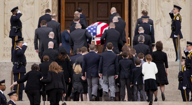 Family members follow behind the casket of the late Supreme Court Associate Justice Antonin Scalia as they arrive for a funeral mass at the Basilica of the National Shrine of the Immaculate Conception in Washington, Saturday.
