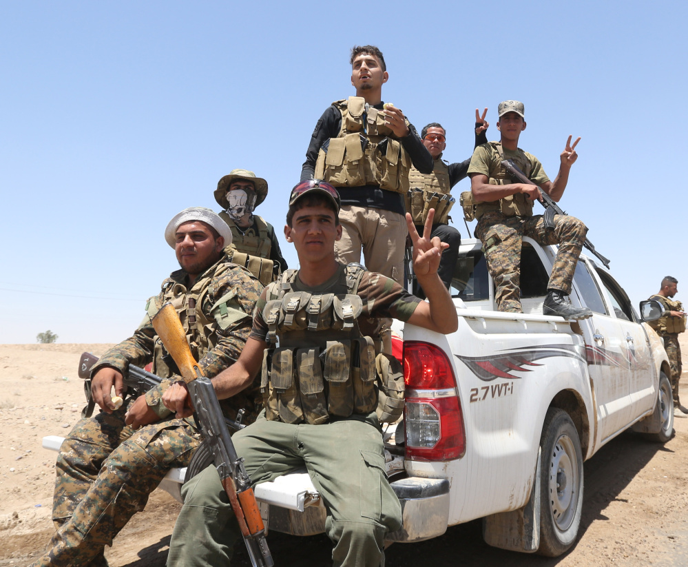 Fighters from the Badr Brigades Shiite militia patrol near Fallujah last summer. Militiamen continue to pour into Iraq’s Anbar province in hopes of retaking the city from the Islamic State.