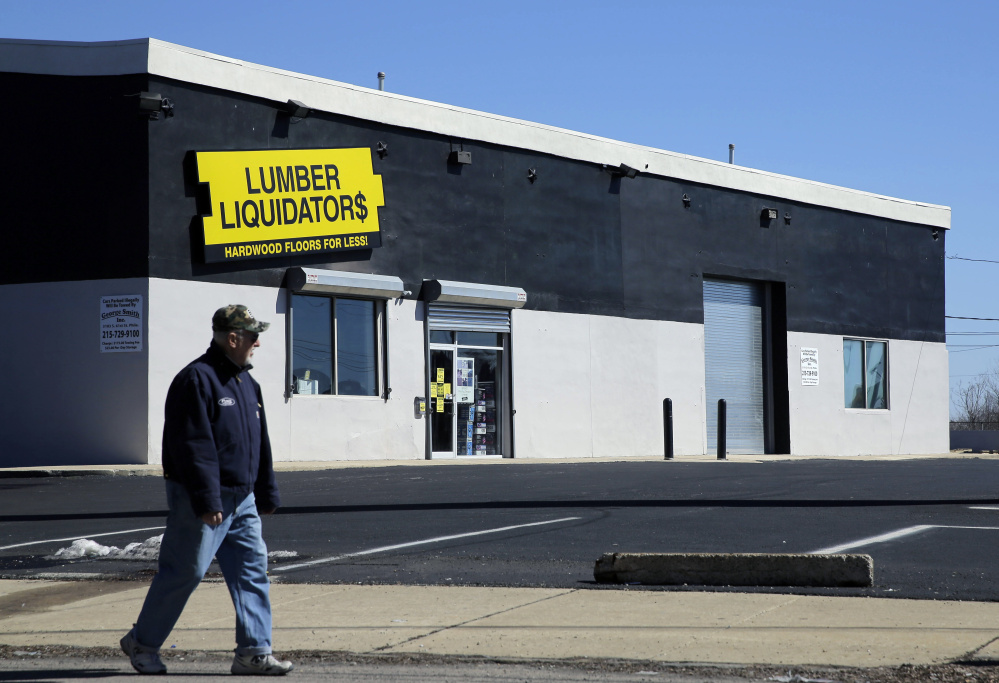 A man walks past a Lumber Liquidators store in Philadelphia. The company stopped selling laminate floors made in China last May after reports they held high levels of formaldehyde.