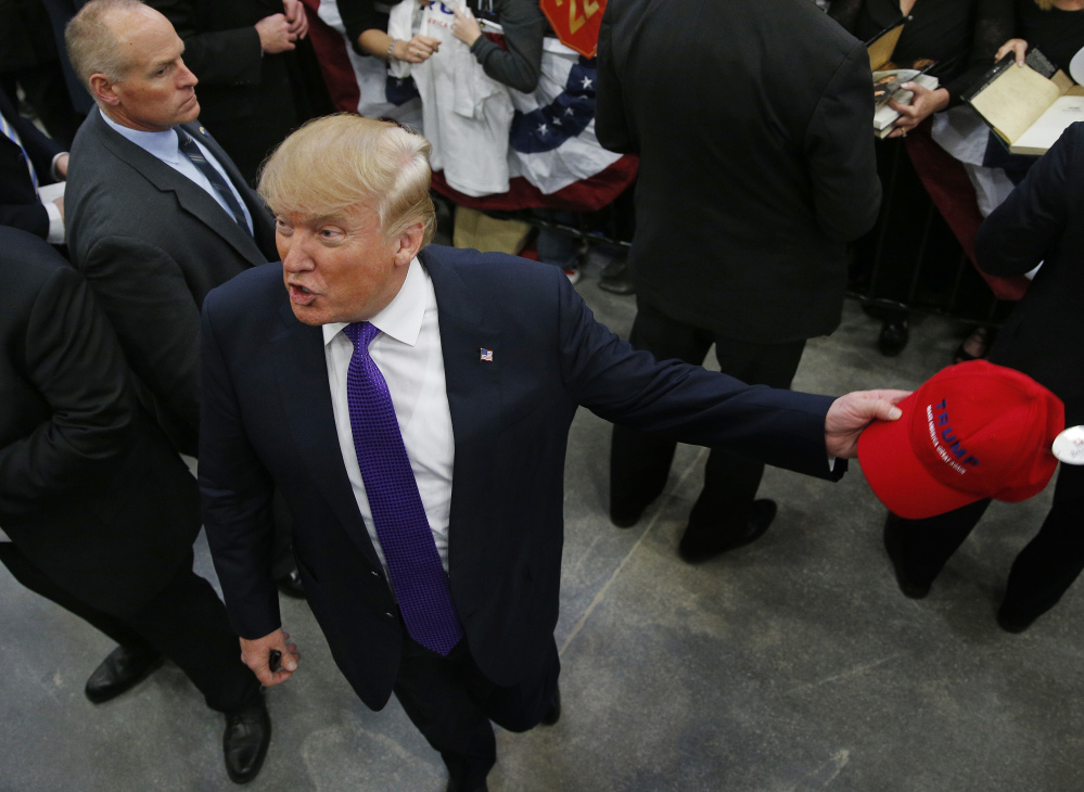 Republican presidential candidate Donald Trump motions to photographers at a campaign rally Monday in Las Vegas.