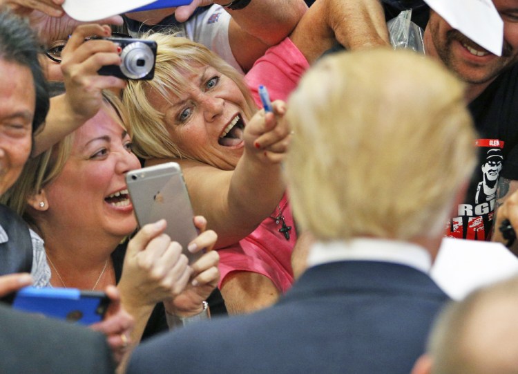 Supporters show their excitement at meeting Republican presidential candidate Donald Trump at a campaign rally Monday in Las Vegas.