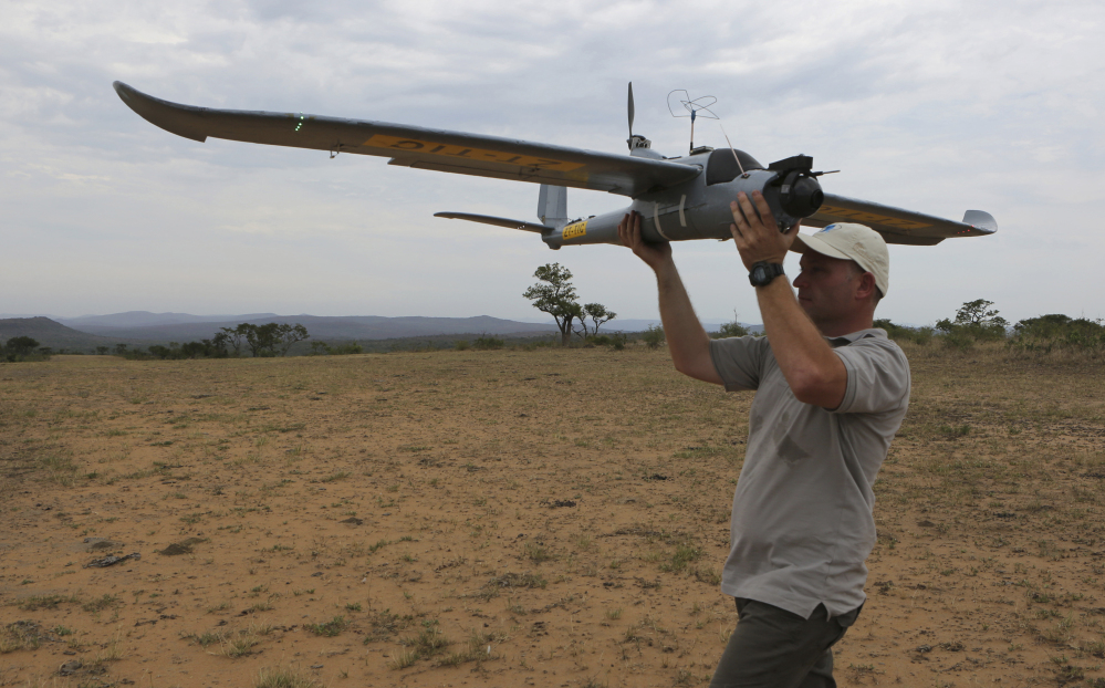 A drone is prepared for launching in the Hluhluwe-iMfolozi Game Reserve in South Africa. Once in flight, conservationists can scan live video from a camera attached to the drone, which can help locate poachers stalking rhinos and other threatened species.