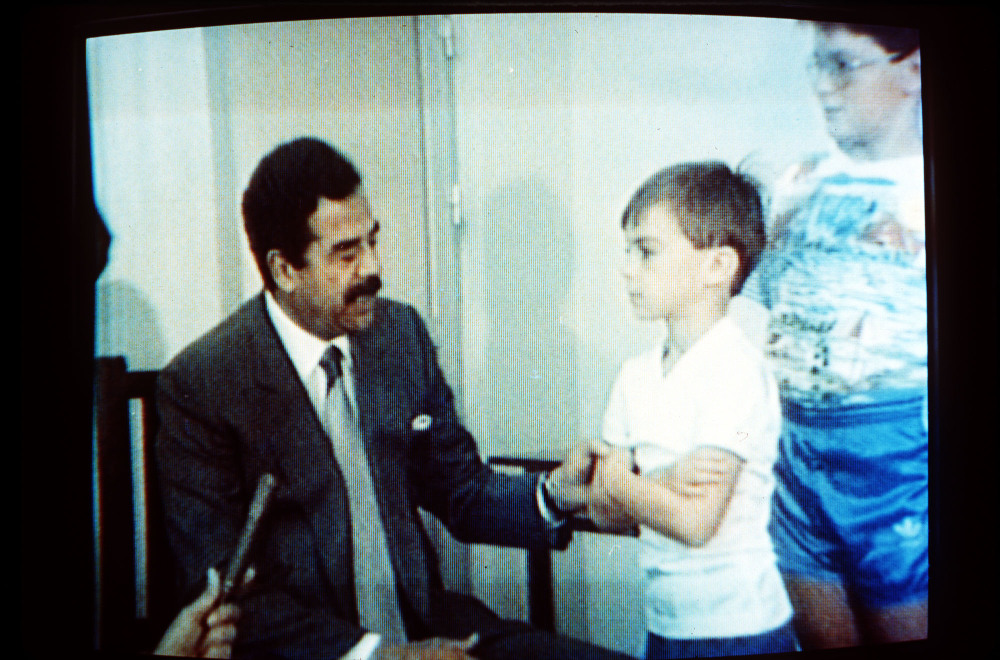 FILE -- In this undated 1990 file photo, Iraqi President Saddam Hussein, speaks with Western British hostages in an image made from Iraqi TV. Twenty five years after the first U.S. Marines swept across the border into Kuwait in the 1991 Gulf War, American forces find themselves battling the extremist Islamic State group, born out of al-Qaida, in the splintered territories of Iraq and Syria. The Arab allies that joined the 1991 coalition are fighting their own conflicts both at home and abroad, as Iran vies for greater regional power following a nuclear deal with world powers. (AP Photo, File)