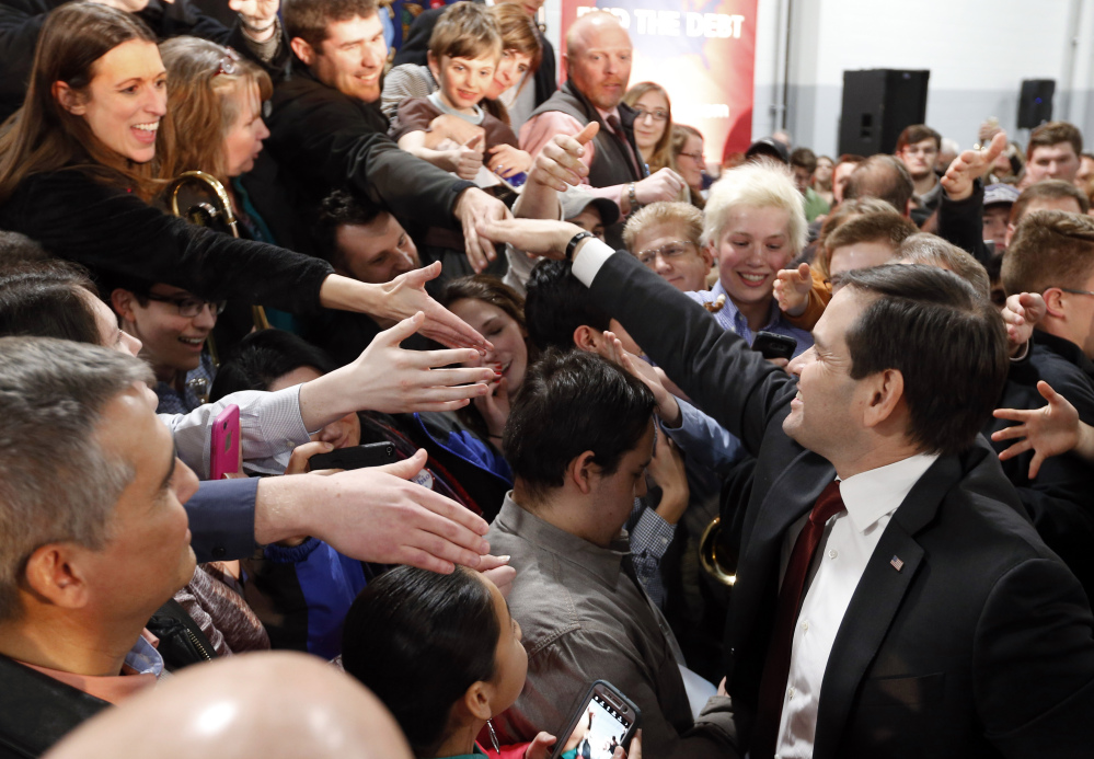 Republican presidential candidate, Sen. Marco Rubio, R-Fla., shakes hands with audience members during a campaign event, Tuesday in Kentwood, Mich.