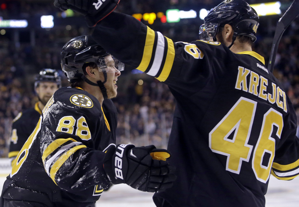 David Pastrnak celebrates his second goal of the game against the Pittsburgh Penguins with teammate David Krejci in the second period Wednesday night in Boston. Pastrnak also scored on a first-period penalty shot.