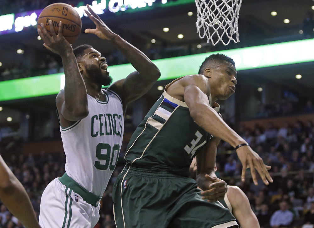 Celtics forward Amir Johnson scores against Milwaukee forward Giannis Antetokounmpo in the first quarter Thursday night in Boston.