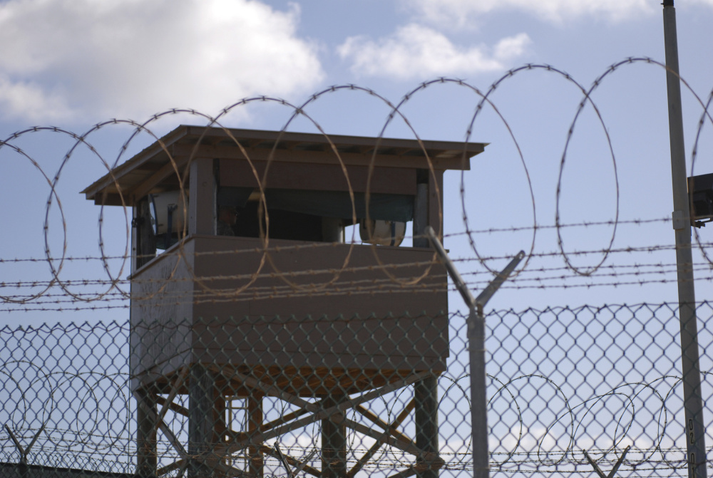 A soldier stands guard in a tower overlooking Camp Delta at Guantanamo Bay Naval Base in a 2009 photo provided by the Navy. The problem with the prison is not as much its physical presence as its symbolic importance.