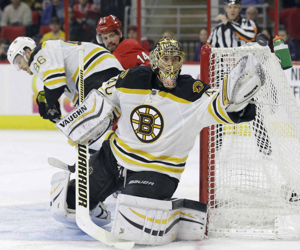 Bruins goalie Tuukka Rask deflects a shot in the second period of Friday night’s game at Raleigh, North Carolina.