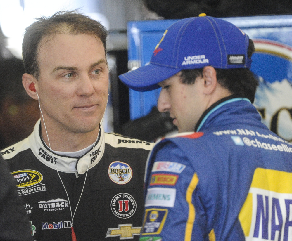 Kevin Harvick, left, and Chase Elliott talk during practice for Sunday’s Sprint Cup race in Georgia. Harvick spoke Friday about Stewart-Haas Racing’s surprising move to Ford in 2017.