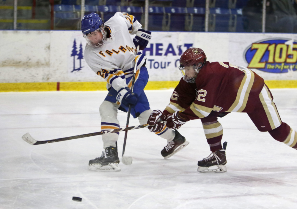 Chase Wescott of Thornton Academy attempts to block a pass by Falmouth’s Alex Grade in the third period of Class A South semifinal Saturday at Lewiston.