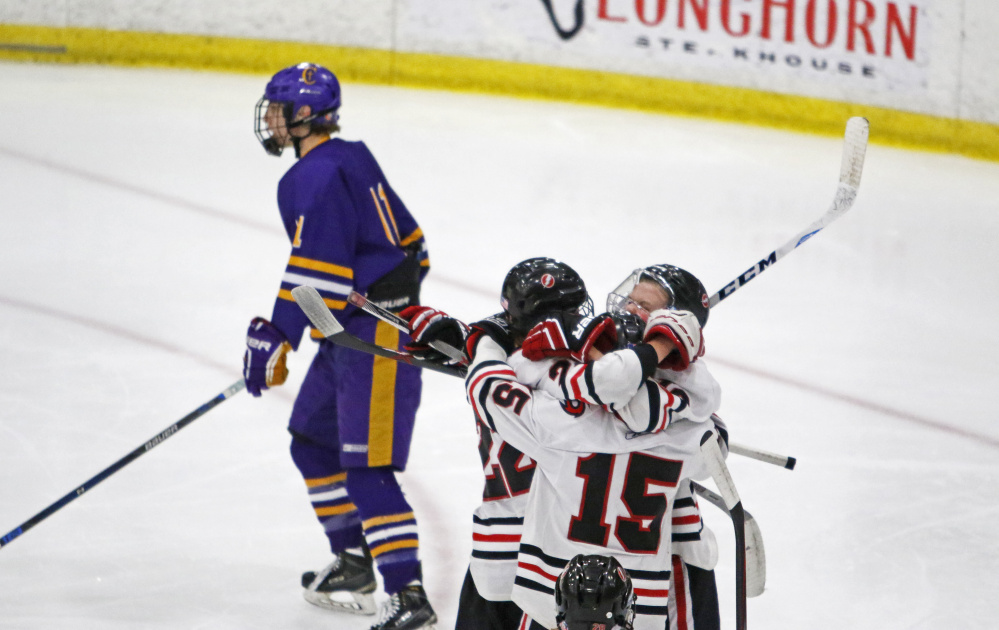 Scarborough celebrates a third-period goal by Skylar Pettingill (16) during Saturday’s Class A South semifinal in Lewiston. The Red Storm beat Cheverus 4-1.