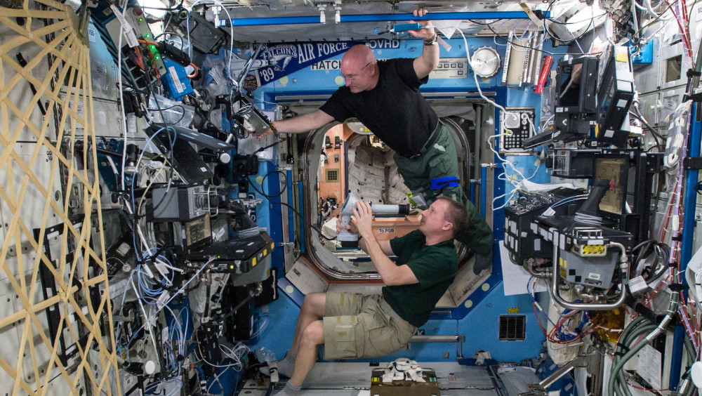 Astronauts Terry Virts, bottom, and Scott Kelly perform eye exams to study vision health last April in the Destiny Laboratory of the International Space Station. Kelly sees his nearly completed one-year mission as a steppingstone to Mars.