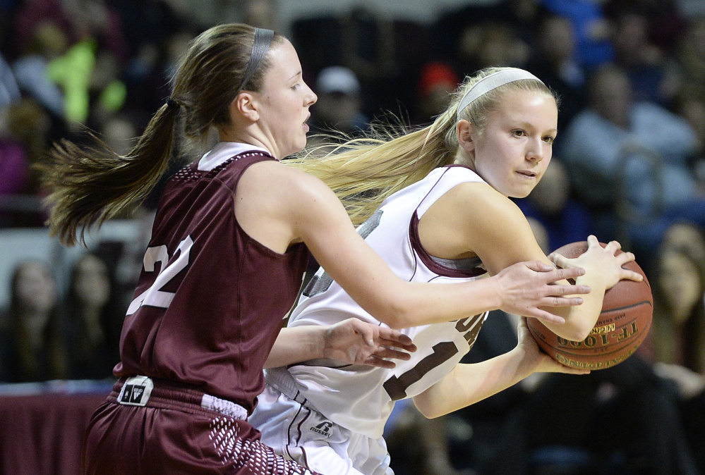 Gorham’s Emily Bragg looks for an open teammate while being defended by Edward Little’s Piper Norcross during the Rams’ 46-36 win in the Class AA state championship game Saturday.