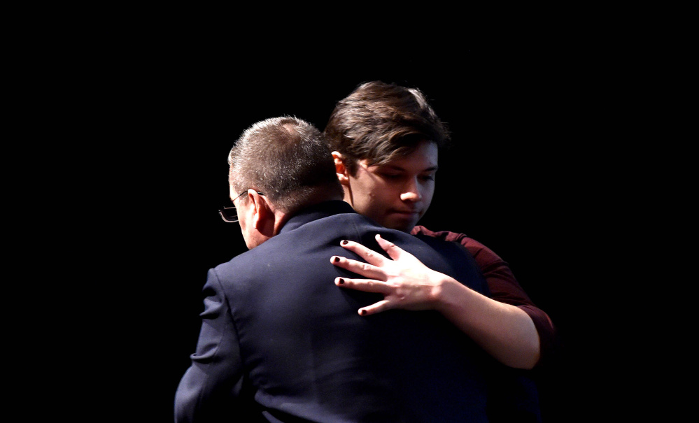 Wayne Maines embraces his son, Jonas, after a presentation at the University of Maine at Farmington about tolerance and acceptance. Nicole Maines, Jonas’ twin, is the subject of the book “Becoming Nicole,” which chronicles the challenges she faced as a transgender youth in Orono.