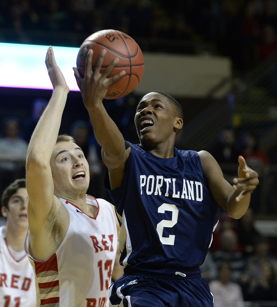 Portland’s Terion Moss drives to the basket against South Portland’s Jack Fiorini in the Class AA boys’ basketball state championship game Saturday at Cross Insurance Arena.