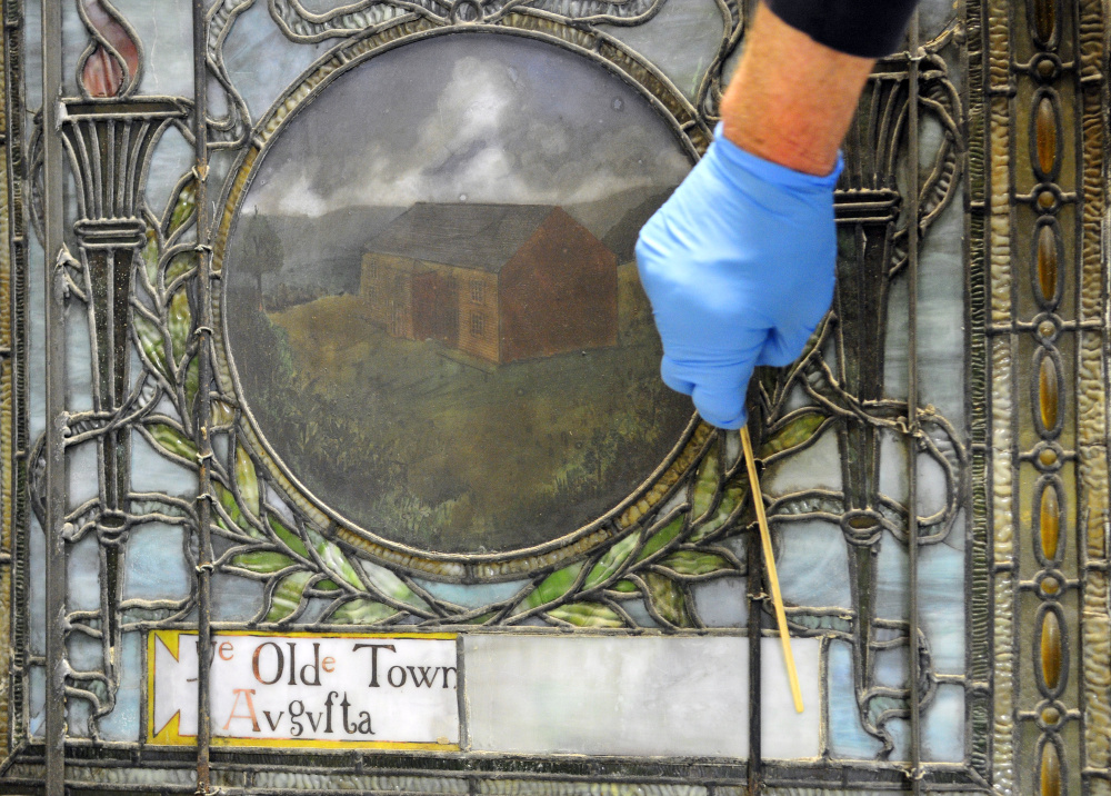 One of the unrestored windows from Lithgow Public Library on Thursday at Stained Glass Express in Manchester. Robert Bolton said that the solid white piece beside the square reading Old Town Augusta probably used to have more words on it.