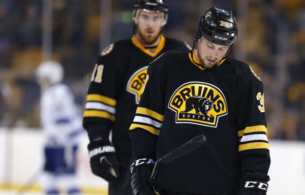 Boston’s Matt Beleskey, front, and Jimmy Hayes skate toward the bench after the Bruins’ 4-1 loss to the Tampa Bay Lightning on Sunday in Boston.