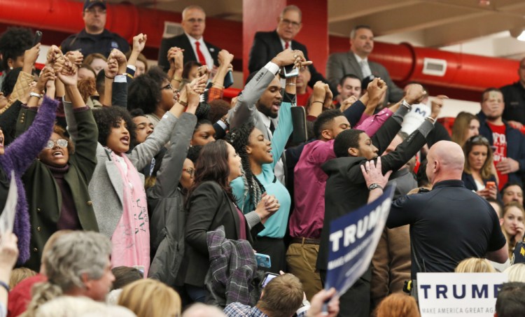 Protesters yell as they are escorted out of a rally for Republican presidential candidate, Donald Trump at Radford University in Radford, Va., Monday.