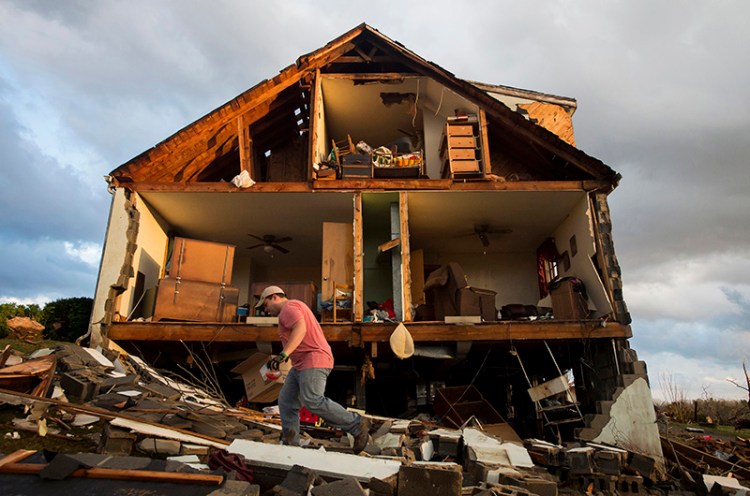 Nick Mobley helps clean up a house owned by a family friend on Wednesday, after a storm hit Appomattox County, Va.