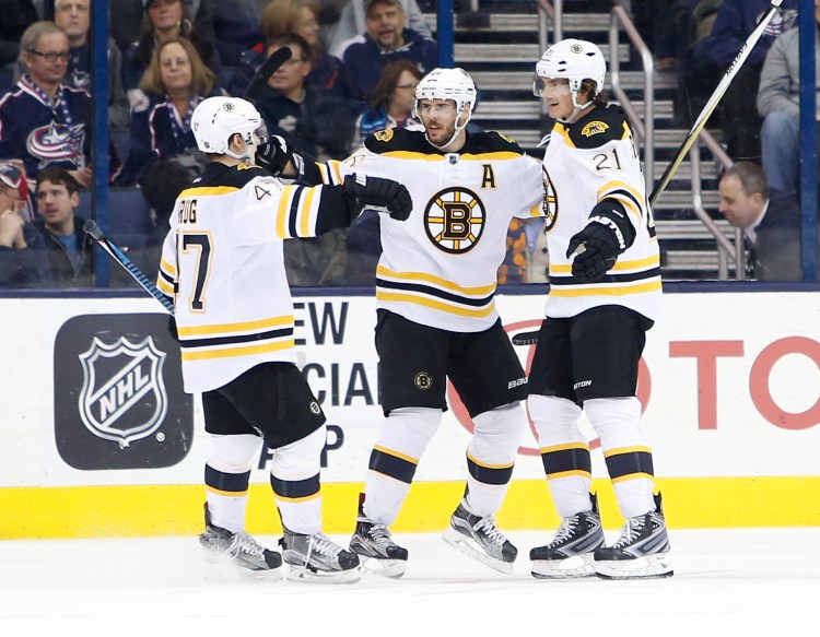 Boston's Loui Eriksson, right, celebrates his game-winning goal against the Columbus Blue Jackets with teammates Torey Krug, left, and David Krejci on Tuesday night.

The Associated Press